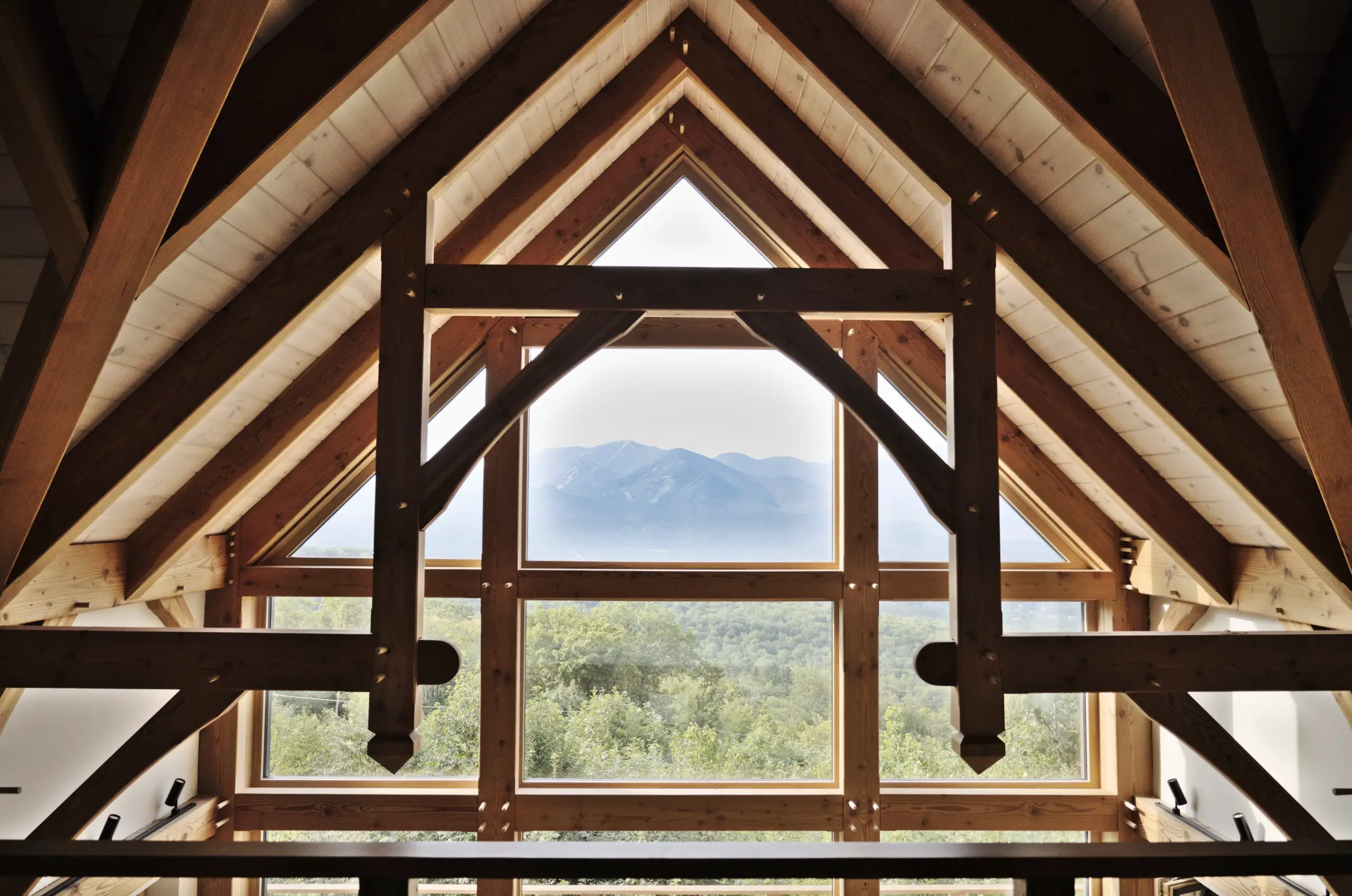 Wooden trusses on ceiling and wooden framed glass window